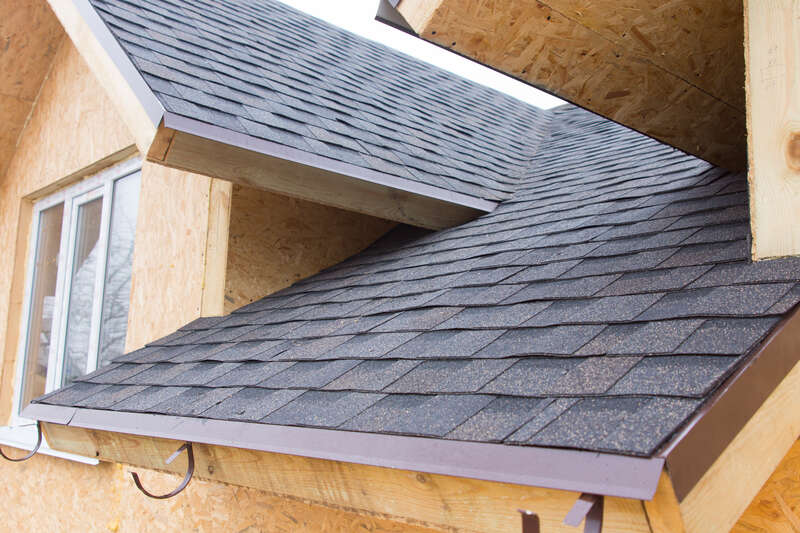 Newly installed shingles on a home under construction
